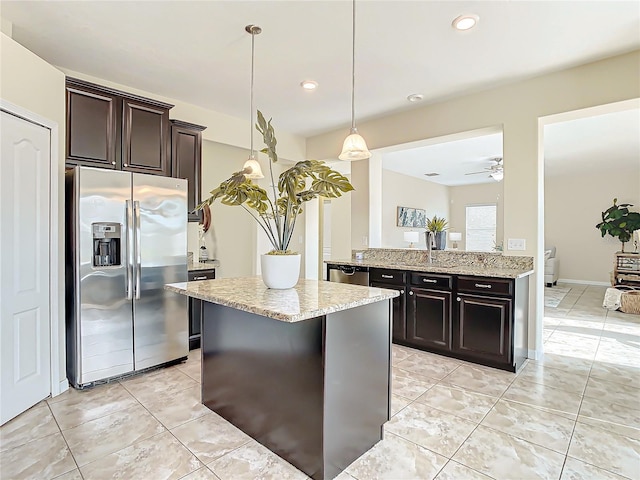 kitchen with kitchen peninsula, appliances with stainless steel finishes, dark brown cabinets, ceiling fan, and hanging light fixtures