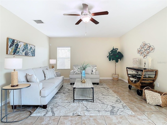 living room with ceiling fan and light tile patterned floors