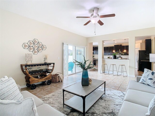 living room with ceiling fan and light tile patterned flooring