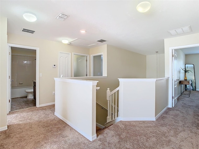 corridor with light colored carpet