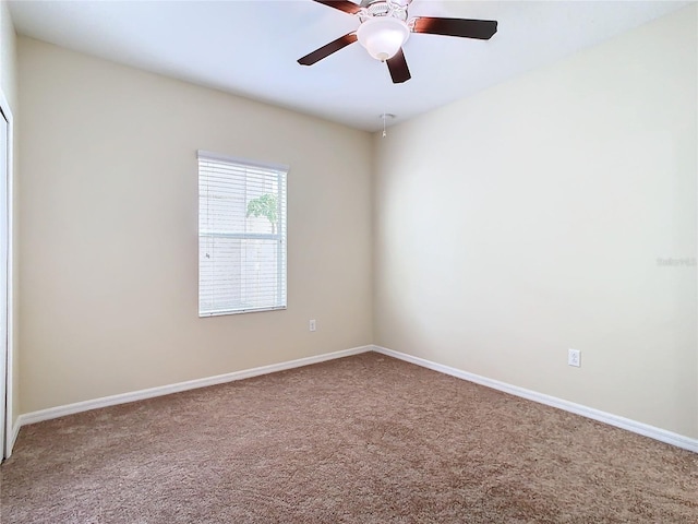 carpeted spare room with ceiling fan