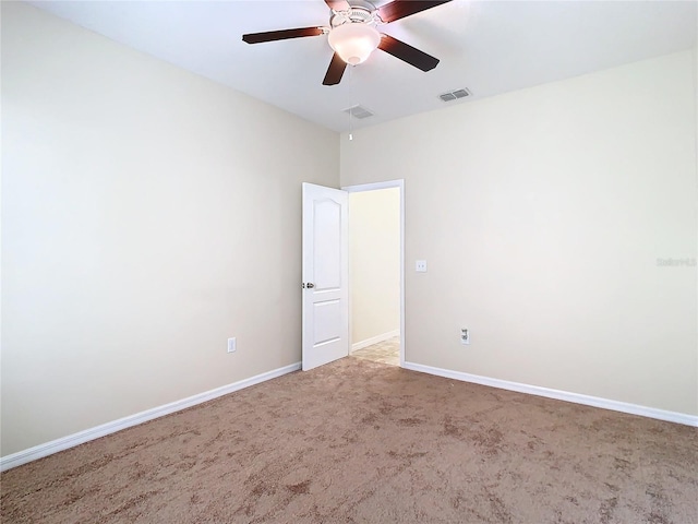 carpeted spare room featuring ceiling fan