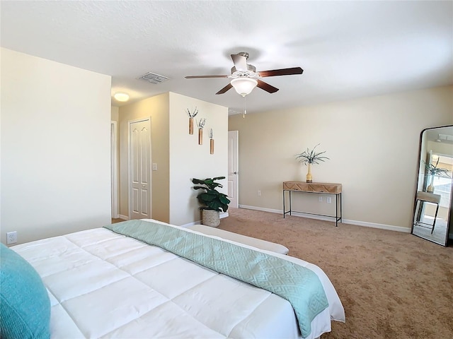 carpeted bedroom featuring ceiling fan and a closet