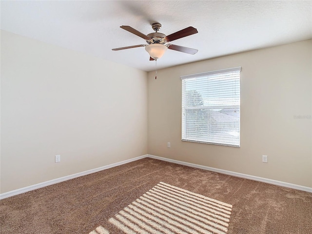 carpeted spare room with ceiling fan