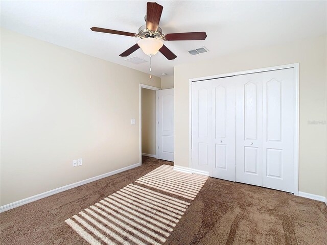 unfurnished bedroom featuring carpet, a closet, and ceiling fan