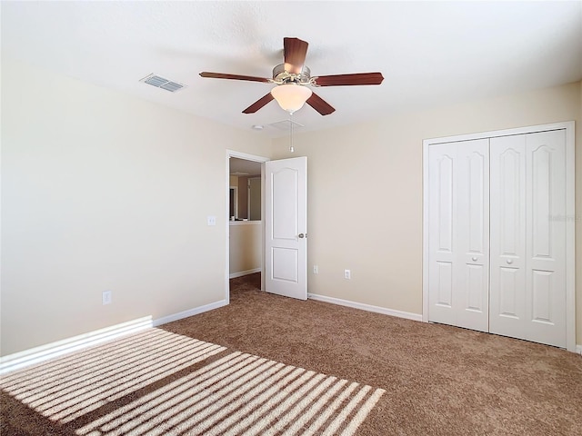 unfurnished bedroom with ceiling fan, a closet, and carpet floors