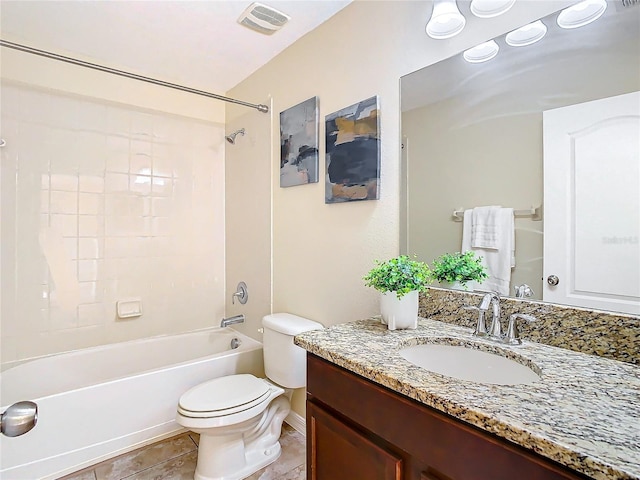 full bathroom featuring washtub / shower combination, tile patterned floors, vanity, and toilet