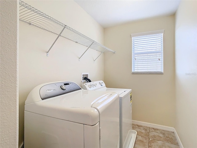 washroom featuring washer and dryer and light tile patterned floors