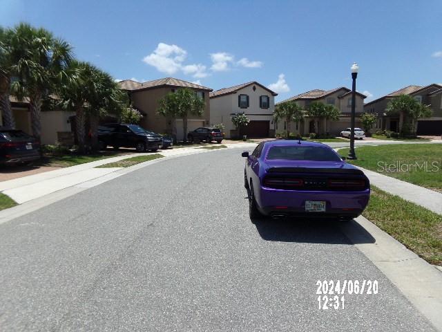 5537 Misty Oak Cir, Davenport, FL 33837 - view of asphalt street featuring street lighting, a residential view, and sidewalks
