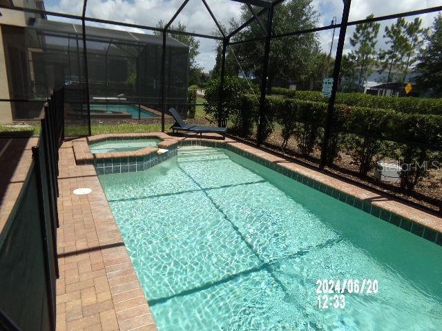 5537 Misty Oak Cir, Davenport, FL 33837 - view of pool featuring a lanai, a pool with connected hot tub, and a patio