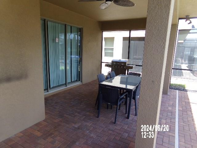 5537 Misty Oak Cir, Davenport, FL 33837 - view of patio featuring ceiling fan, grilling area, and outdoor dining space