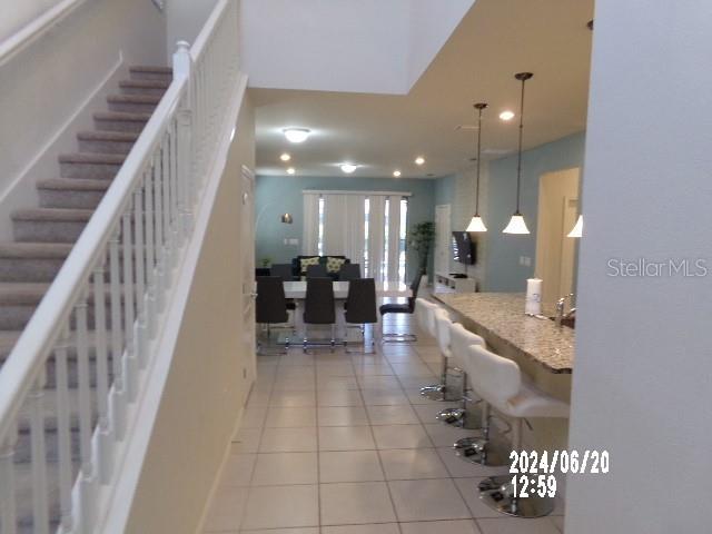 stairway featuring tile patterned flooring