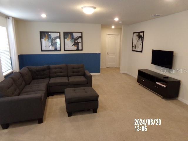 5537 Misty Oak Cir, Davenport, FL 33837 - living room featuring light carpet and recessed lighting