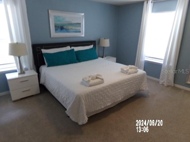5537 Misty Oak Cir, Davenport, FL 33837 - bedroom featuring light colored carpet and baseboards