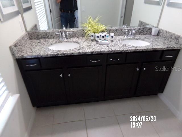 5537 Misty Oak Cir, Davenport, FL 33837 - bathroom with double vanity and tile patterned flooring
