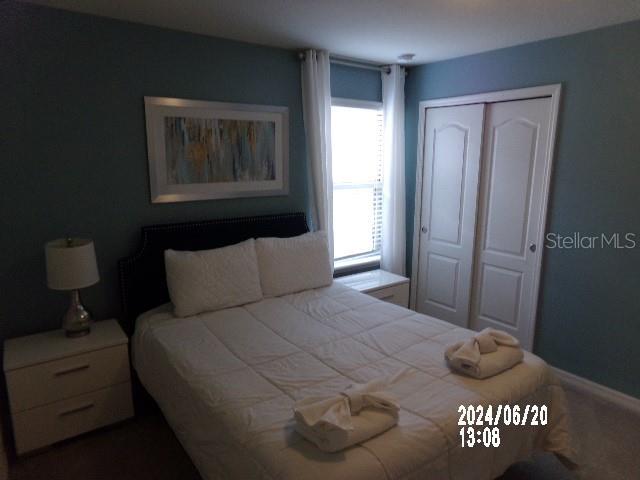 5537 Misty Oak Cir, Davenport, FL 33837 - bedroom with a closet and dark colored carpet