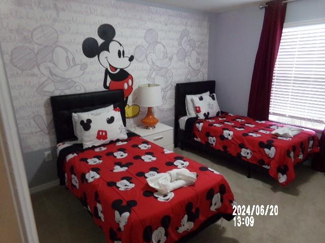 5537 Misty Oak Cir, Davenport, FL 33837 - bedroom featuring multiple windows and carpet flooring