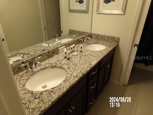 5537 Misty Oak Cir, Davenport, FL 33837 - full bathroom with double vanity and tile patterned flooring