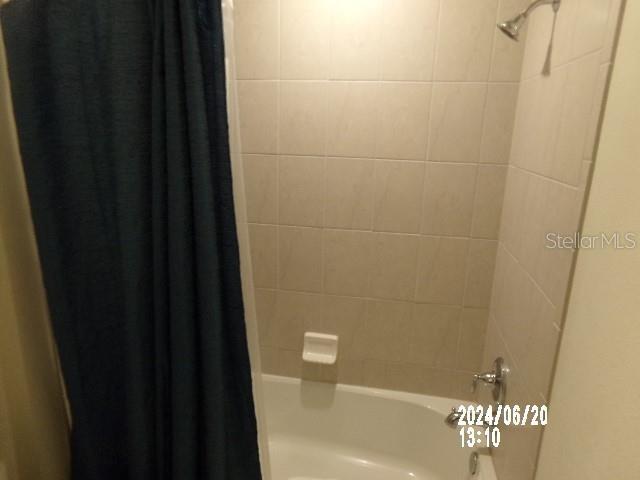 5537 Misty Oak Cir, Davenport, FL 33837 - full bathroom with shower / bath combo with shower curtain
