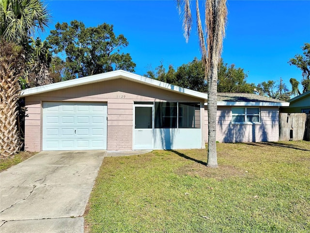 view of front of home with a front lawn and a garage