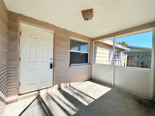 view of exterior entry featuring a patio area