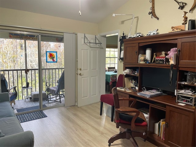 home office featuring light hardwood / wood-style floors and lofted ceiling