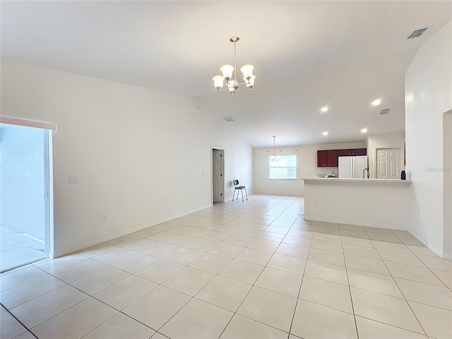 unfurnished living room featuring lofted ceiling, light tile patterned floors, and an inviting chandelier