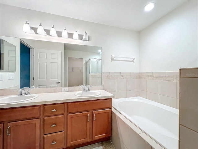 bathroom with vanity and independent shower and bath