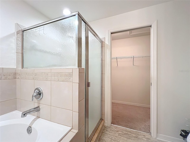 bathroom featuring plus walk in shower