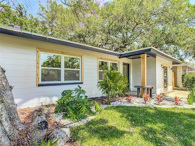 view of side of property with a lawn