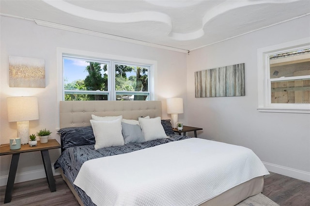 bedroom with dark hardwood / wood-style flooring