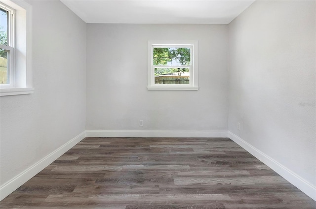 spare room with dark hardwood / wood-style flooring