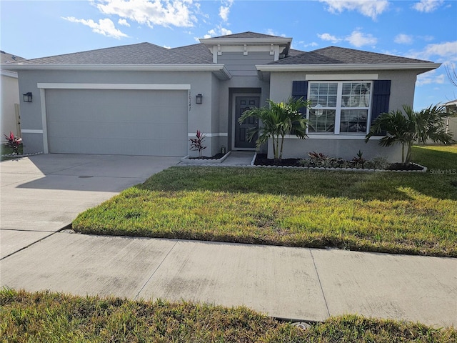 view of front of home with a front yard and a garage