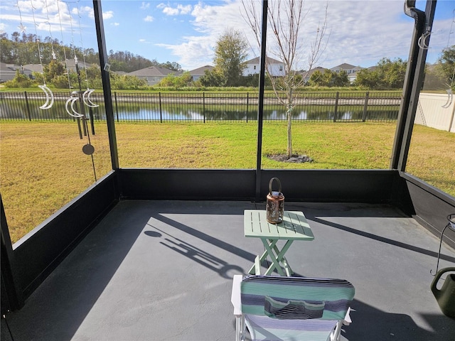 sunroom / solarium with a water view