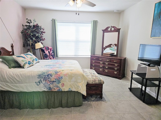 tiled bedroom featuring ceiling fan