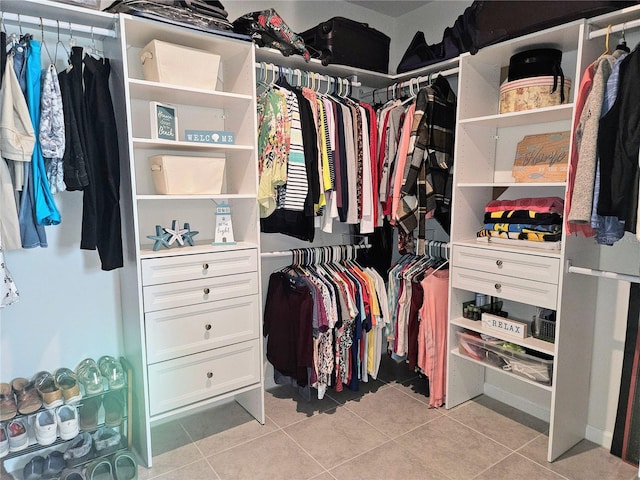 walk in closet with light tile patterned floors