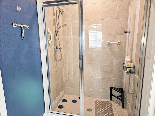 bathroom with a shower with door