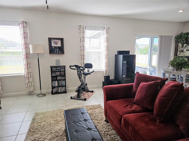 living room featuring a textured ceiling and light tile patterned flooring