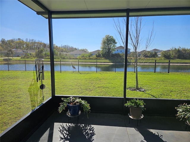 unfurnished sunroom featuring plenty of natural light and a water view