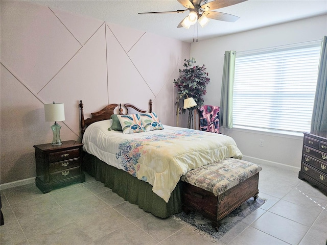 bedroom featuring light tile patterned flooring, baseboards, and ceiling fan