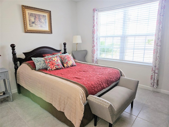 bedroom with tile patterned floors and baseboards