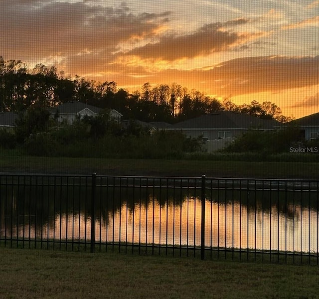 view of yard featuring fence and a water view