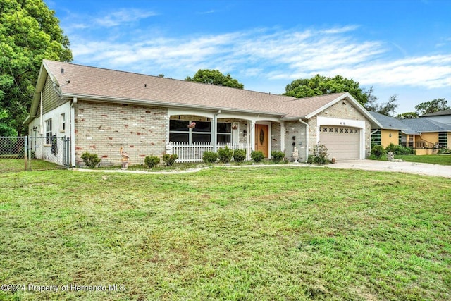 ranch-style house with a front lawn, a porch, and a garage