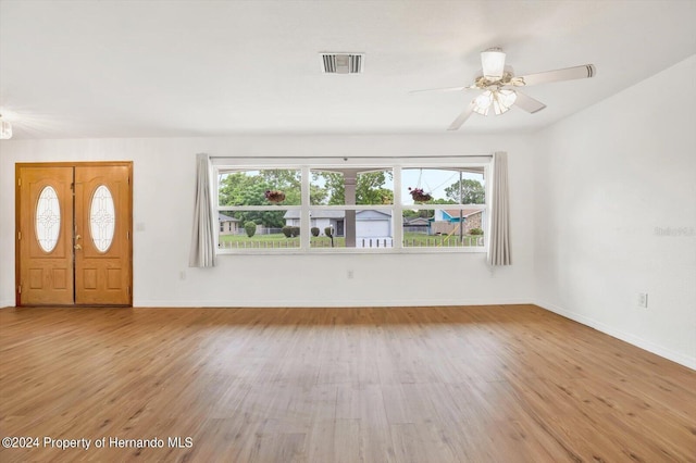 foyer entrance with a wealth of natural light, ceiling fan, and light wood-type flooring