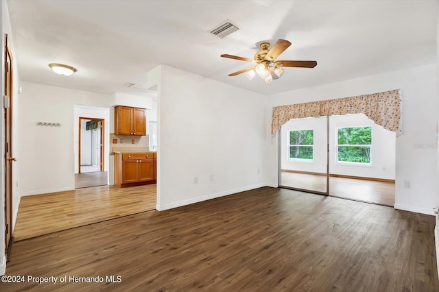 spare room featuring dark hardwood / wood-style floors and ceiling fan