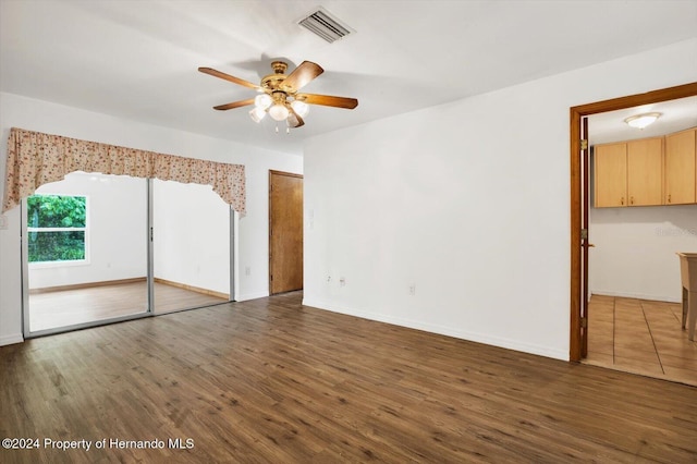 unfurnished bedroom with ceiling fan and dark hardwood / wood-style flooring