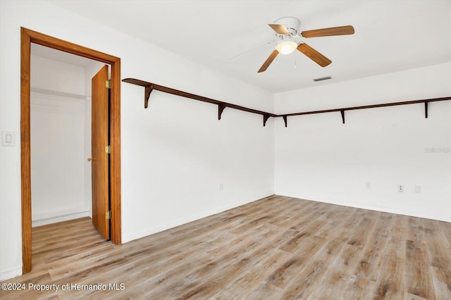 empty room featuring ceiling fan and light wood-type flooring