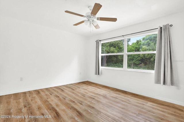 empty room with light hardwood / wood-style flooring and ceiling fan