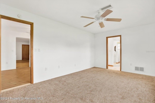 carpeted spare room with ceiling fan