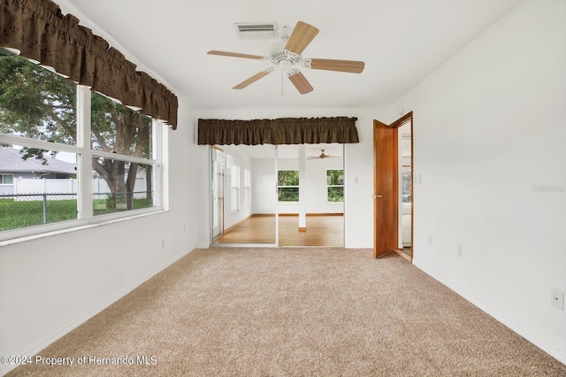 carpeted empty room with ceiling fan